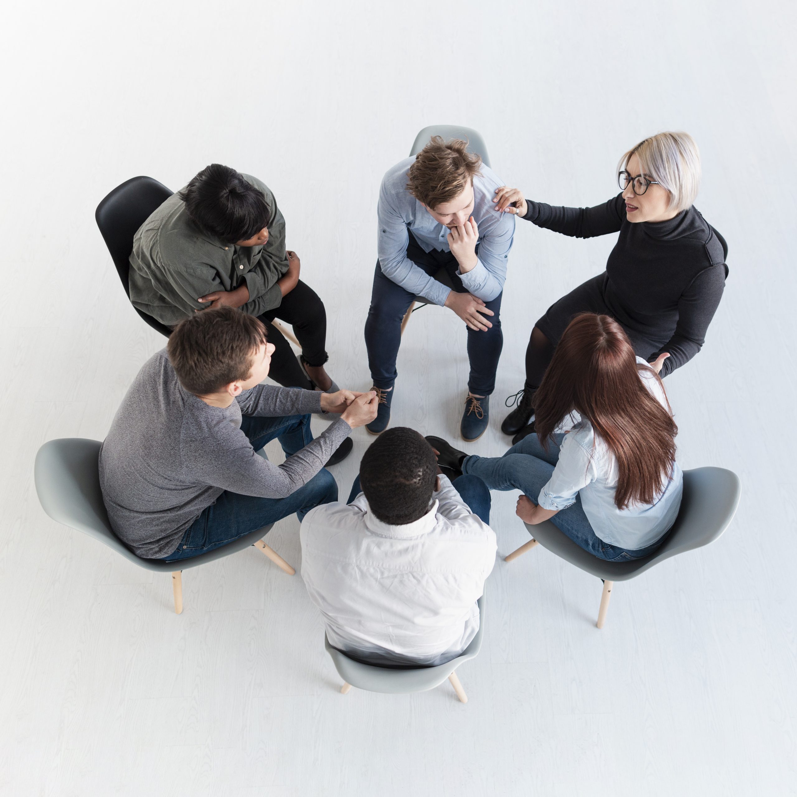 top-view-rehab-patients-standing-circle-talking